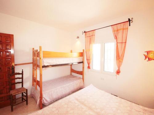 a bedroom with two bunk beds and a window at Calypso in Jávea