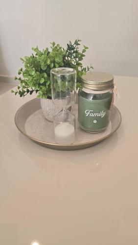 a tray with a candle and plants on a table at Departamento a estrenar en Mburucuya in Asuncion