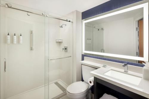 a bathroom with a toilet and a sink and a shower at Fairfield by Marriott Mission Viejo Orange County in Mission Viejo