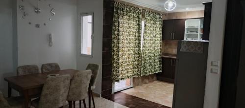 a kitchen and dining room with a table and chairs at Enjoy appartemet in Essaouira