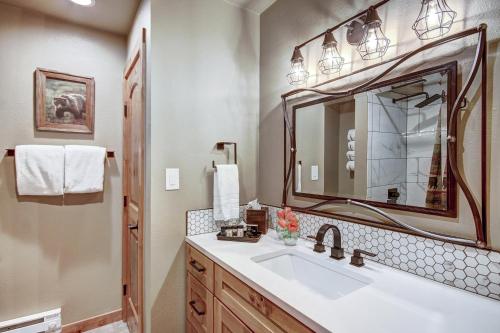 a bathroom with a sink and a mirror at Atrium Unit #108 Condo in Breckenridge