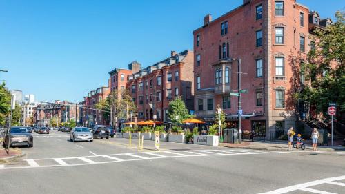 una calle de la ciudad con coches conduciendo por una calle con edificios en South End Luxe Apartment, en Boston