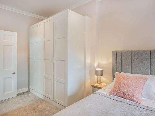 a bedroom with a large white closet and a bed at 1 Bed in Earls Colne 92614 in Earls Colne