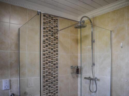 a shower with a glass door in a bathroom at Seaview in Barvas