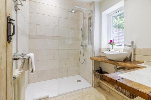 a bathroom with a shower and a sink at Stable Cottage in Ringwood