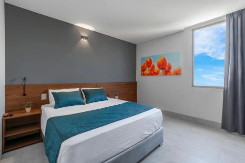 Postel nebo postele na pokoji v ubytování HOTEL RILUX Barrancabermeja
