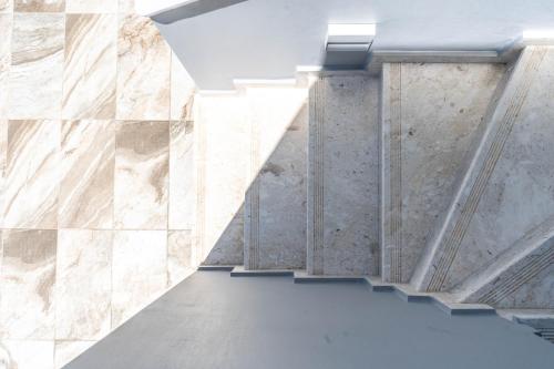an empty room with marble walls and ceilings at Kalon Gaia NOSTOS in Karistos