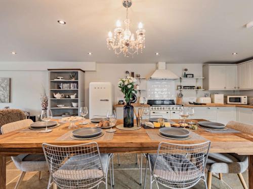 a kitchen with a large wooden table and chairs at 3 Bed in Melton Mowbray 61788 in Melton Mowbray