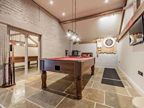 a pool table in a room with a brick wall at 3 Bed in Melton Mowbray 61788 in Melton Mowbray