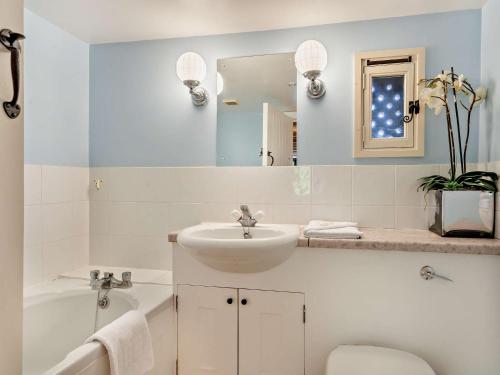 a white bathroom with a sink and a tub and a toilet at 3 Bed in Shaftesbury 95685 in Sedghill