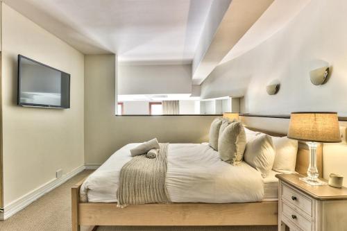 a bedroom with a large bed and a tv at Couples Retreat, Bar, Library, 24 hour Security in Cape Town