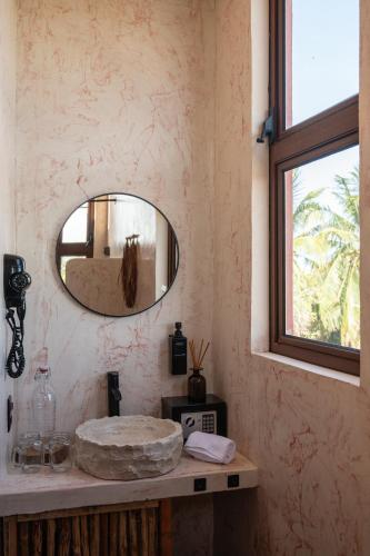 a bathroom with a sink and a mirror at Casa Coyote Holbox in Holbox Island
