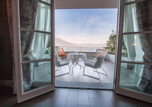 an open door to a balcony with a table and chairs at Borgo Le Terrazze in Bellagio