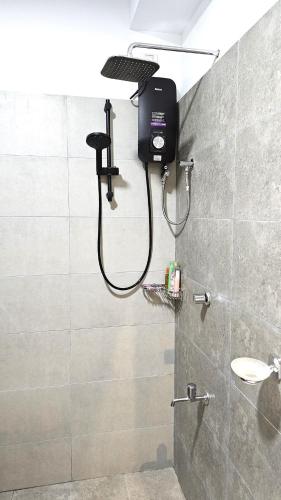 a bathroom with a shower with a shower head at Biyanka's lovely apartment in Sri Jayewardenepura Kotte