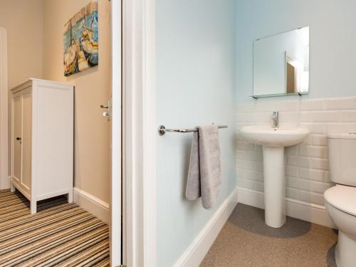 a bathroom with a sink and a toilet at 3 Bed in Eastbourne EHC38 in Eastbourne