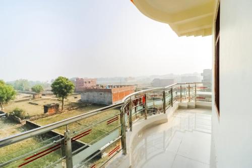 a balcony with a view of a city at Hotel O Arpit Hotel Jhusi Railway Station in Jhūsi