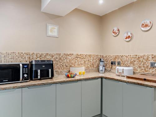 a kitchen with two microwaves on a counter at 4 Bed in Wincle 95651 in Allgreave