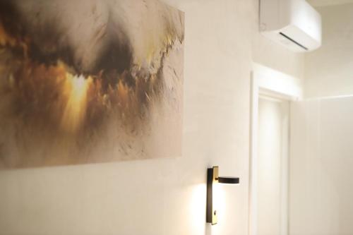 a painting hanging on a wall next to a door at Rooms Kruja City in Krujë