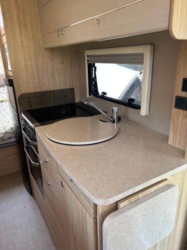 a kitchen with a sink in an rv at Dolafon farm luxury caravan stay in St Asaph