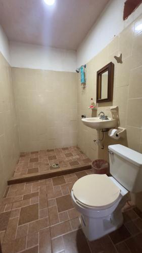 a bathroom with a toilet and a sink at Cabañas Alba in Caleta de Campos