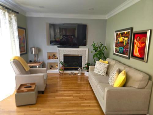 a living room with a couch and a fireplace at Loudoun Metro Station Home in Ashburn