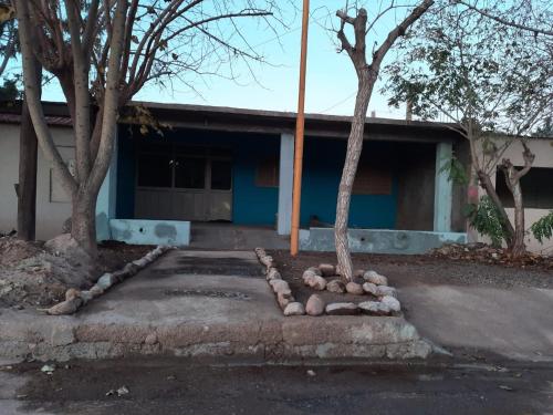 a building with two trees in front of it at Casa Alojamiento TELAR DE SUEÑOS in Belén