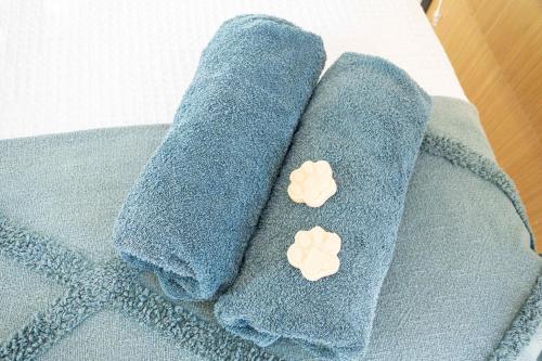 two blue towels with two white buttons on them at Mountview Getaway by Tiny Away in Toonpan