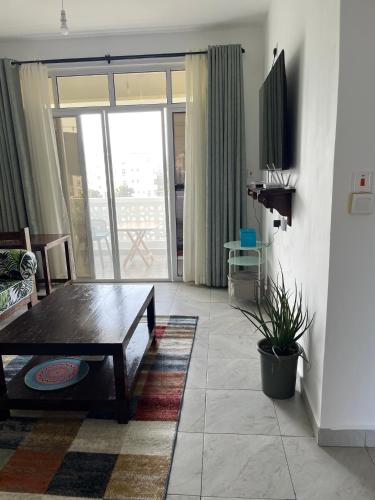 TV a/nebo společenská místnost v ubytování Coral Whispers