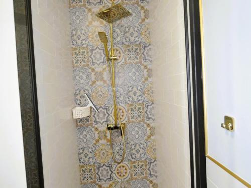 a shower in a bathroom with blue and white tiles at Luxury holiday home for 20 people in Kołczewo