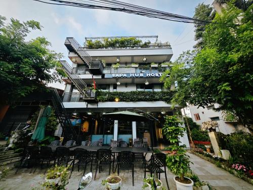 a restaurant with a table and chairs in front of a building at SAPA HUB hostel in Sa Pa