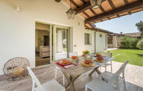 a dining table and chairs on a patio at Nice Home In Montalto Di Castro in Montalto di Castro