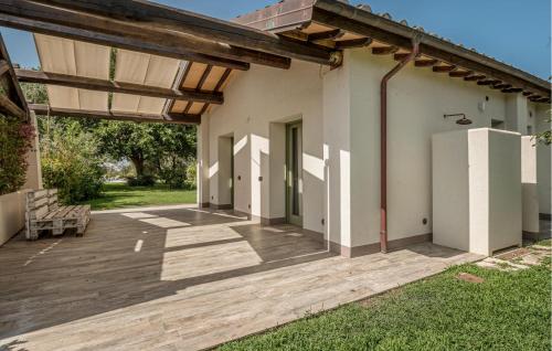 a patio of a house with a wooden deck at Nice Home In Montalto Di Castro in Montalto di Castro