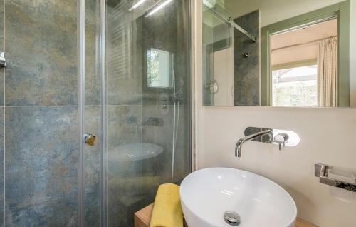 a bathroom with a sink and a shower at Nice Home In Montalto Di Castro in Montalto di Castro