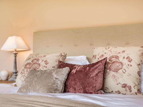 a bedroom with a bed with pillows on it at 4 Bed in Chirk 87675 in Chirk