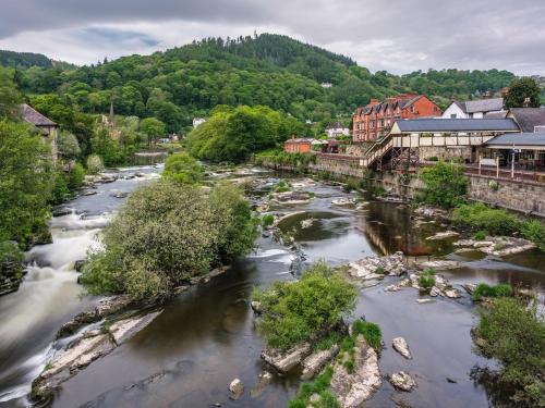 an aerial view of a river in a town at 4 Bed in Chirk 87675 in Chirk