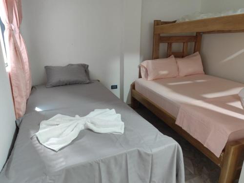 a room with two beds with a bow on it at Habitaciones con wifi a 5 minutos de la playa in Capurganá