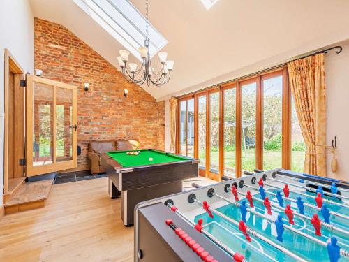 a living room with a pool table and ping pong balls at 5 Bed in Smarden 76428 in Smarden