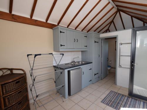a kitchen with white cabinets and a sink at 5 Bed in Smarden 76428 in Smarden