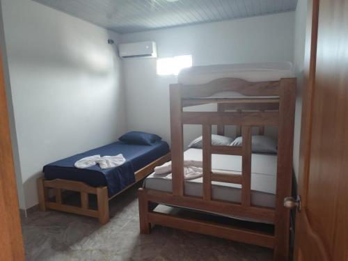 a small room with two bunk beds and a stool at Habitaciones con wifi a 5 minutos de la playa in Capurganá