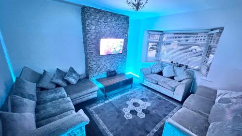 a living room with a couch and a brick wall at Luxproperties in Birmingham
