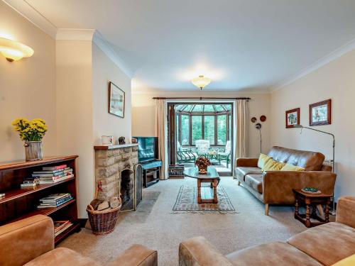 a living room with a couch and a fireplace at 5 Bed in Lower Slaughter 94643 in Lower Slaughter
