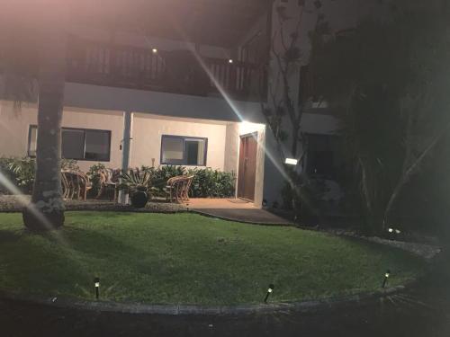 a house with a lawn in front of a building at Seaview House Unit 2A in Whangarei