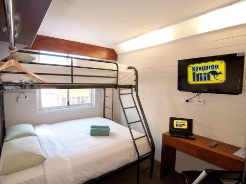 a bedroom with a bunk bed and a television at Kangaroo Inn in Perth