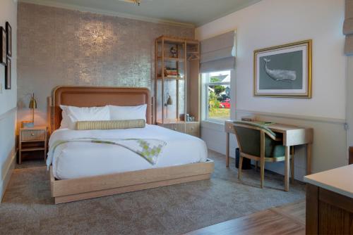 a bedroom with a bed and a desk and a desk at Hotel Sylvia in Newport
