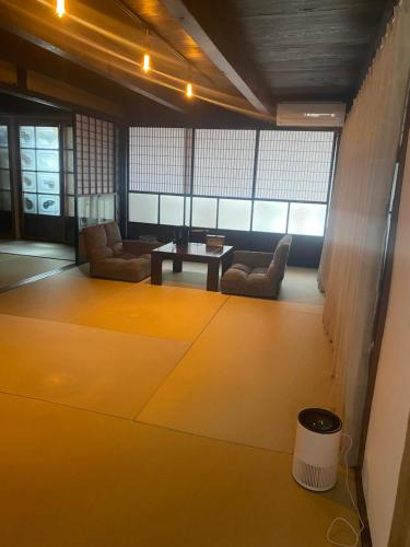 a living room with couches and a table at 古民家宿そらいえ in Asago