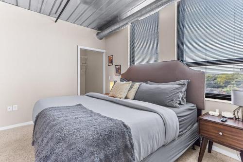 a bedroom with a large bed and a window at 2 Apts w King Beds - Near Kerrytown in Ann Arbor