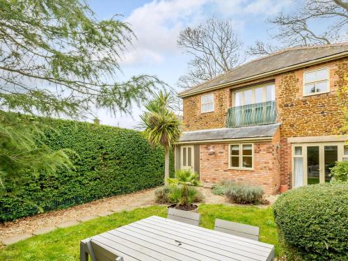 a brick house with a garden in front of it at Ladybird Cottage in Hunstanton