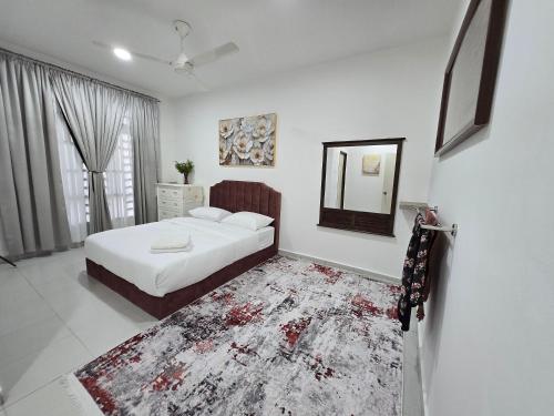 a bedroom with a bed and a mirror and a rug at Homestay DAR AL - HAQEM Full Aircond in Kuantan