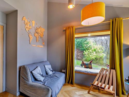 a living room with a chair and a window at 3 Bed in Pitlochry CA207 in Struan