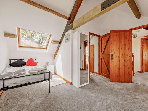 a bedroom with a bed and a wooden door at 4 Bed in Aberaeron 92072 in Llanrhystyd
